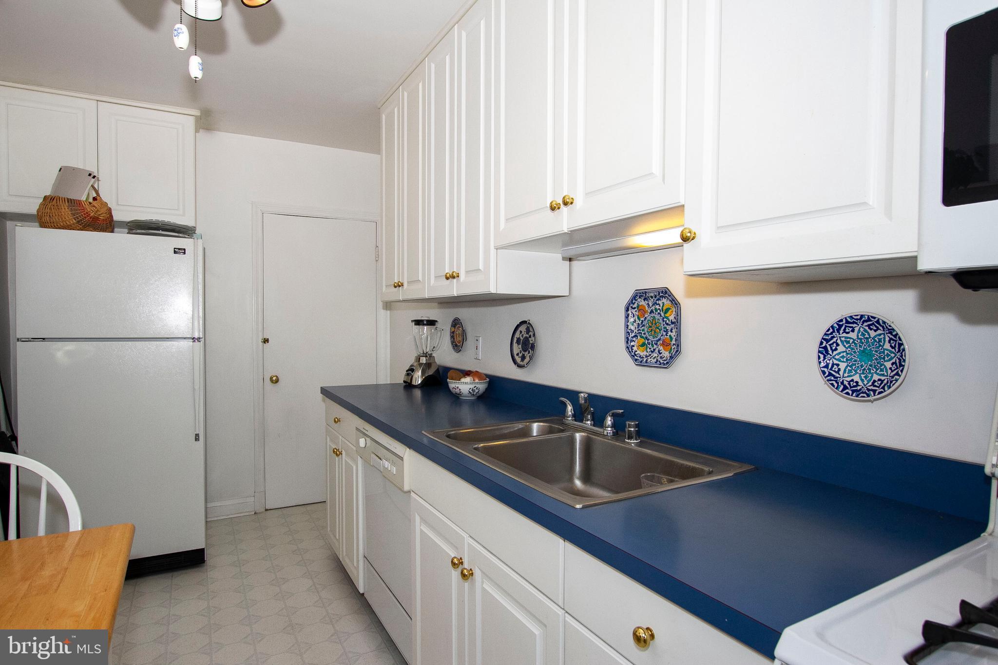7014 Heathfield Road Baltimore, MD 21212 - Photo 11 of 26 Tall white cabinets, Stainless sink, etc