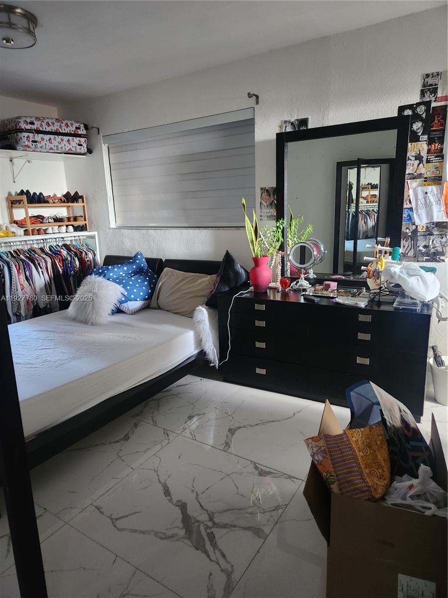 1645 Southwest 83rd Ct. Miami, FL 33155 - Photo 11 of 45 a bedroom with furniture and a potted plant