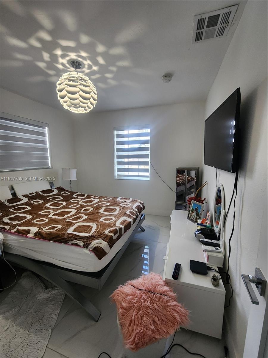 1645 Southwest 83rd Ct. Miami, FL 33155 - Photo 17 of 45 a bedroom with furniture and a flat screen tv