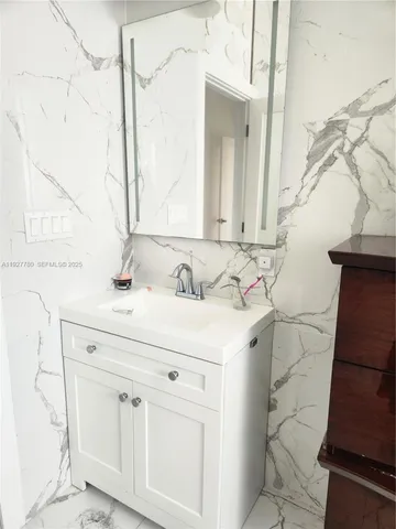 a bathroom with a shower and vanity