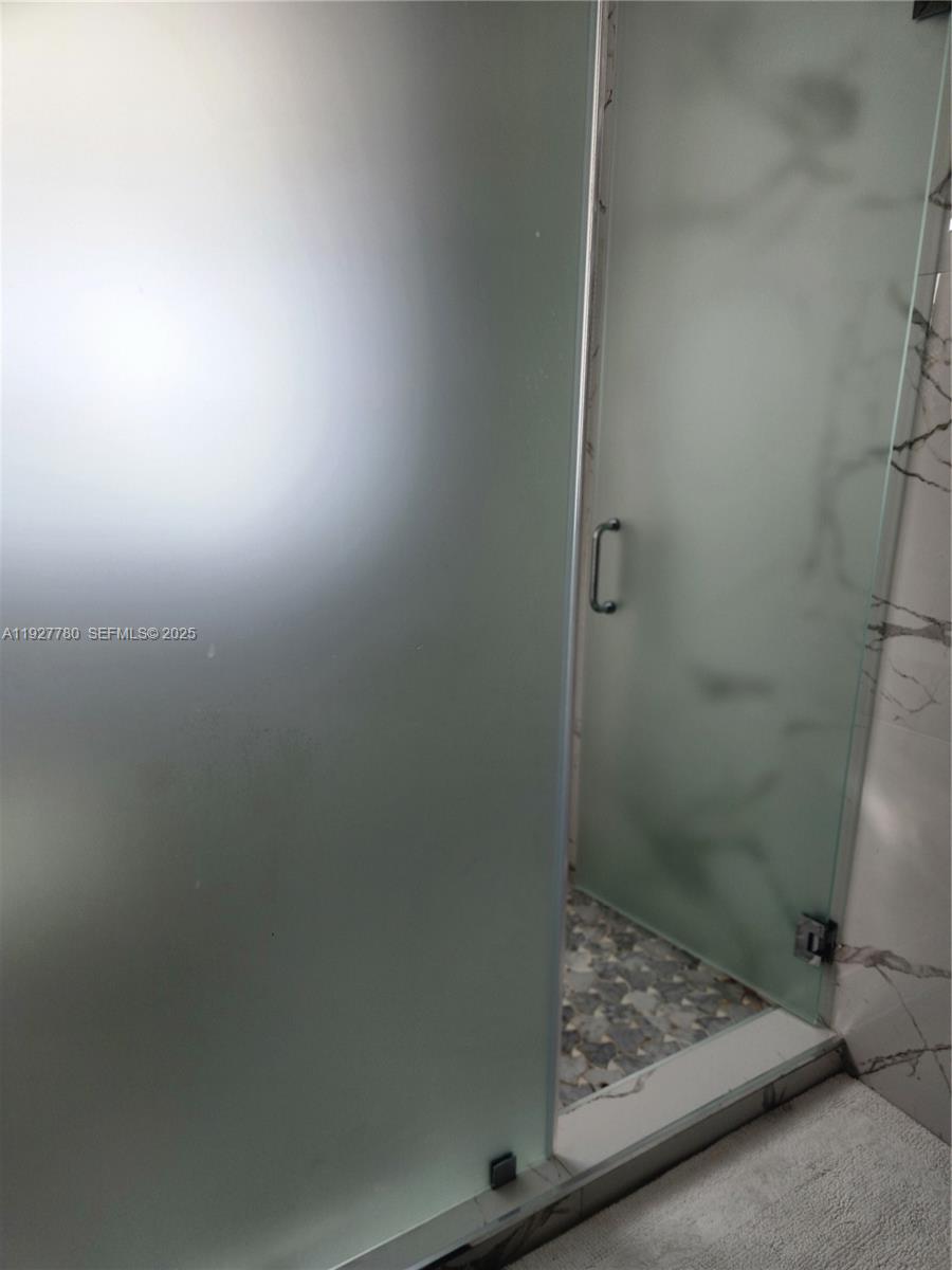 1645 Southwest 83rd Ct. Miami, FL 33155 - Photo 27 of 45 a bathroom with a shower and vanity