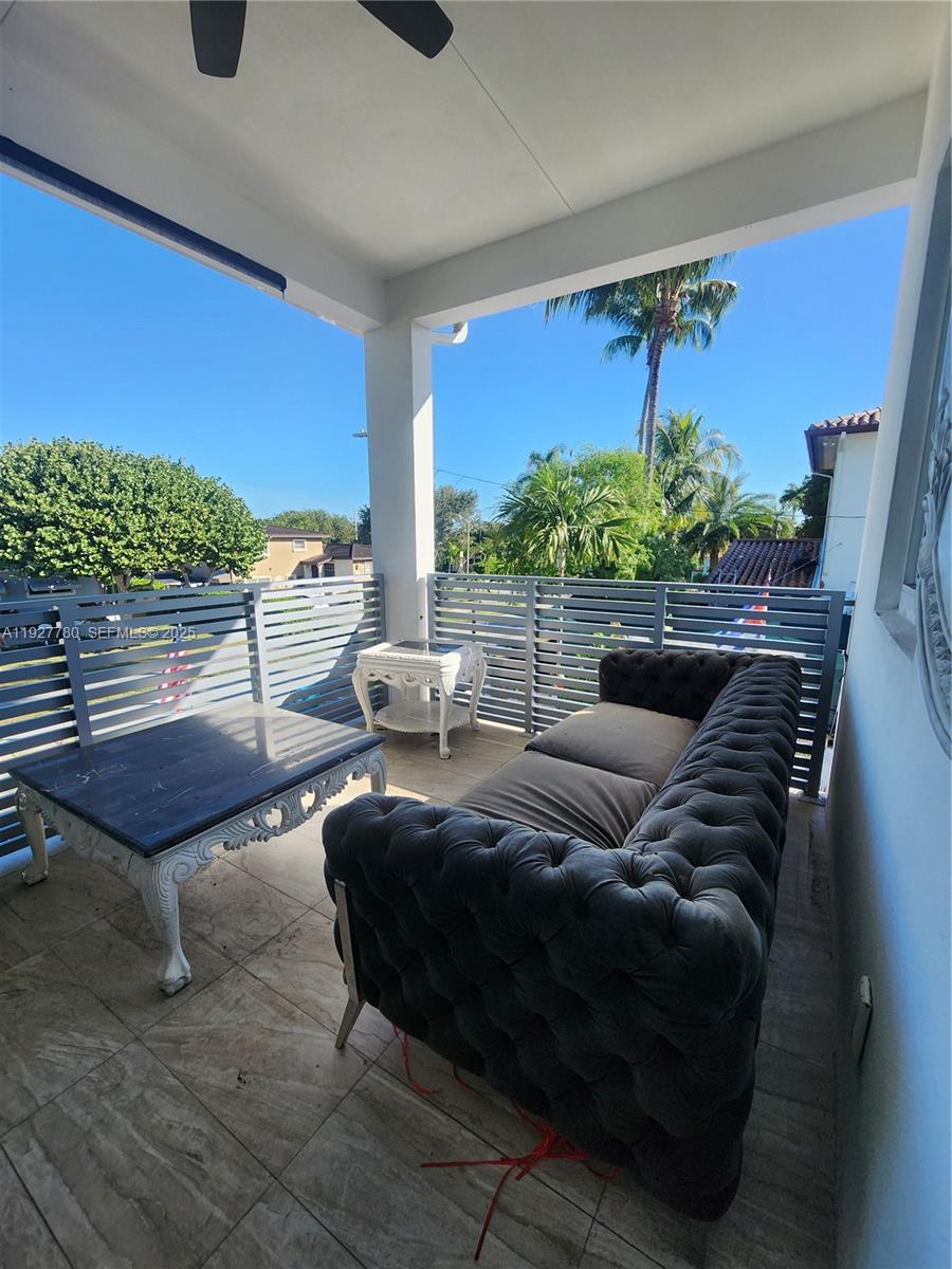 1645 Southwest 83rd Ct. Miami, FL 33155 - Photo 30 of 45 a living room with furniture and a floor to ceiling window