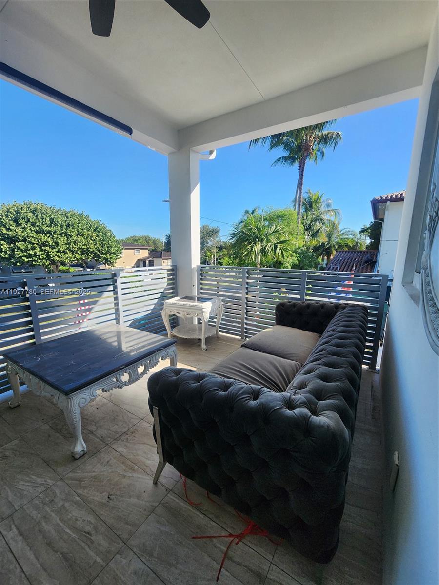 1645 Southwest 83rd Ct. Miami, FL 33155 - Photo 32 of 45 a living room with furniture and a floor to ceiling window