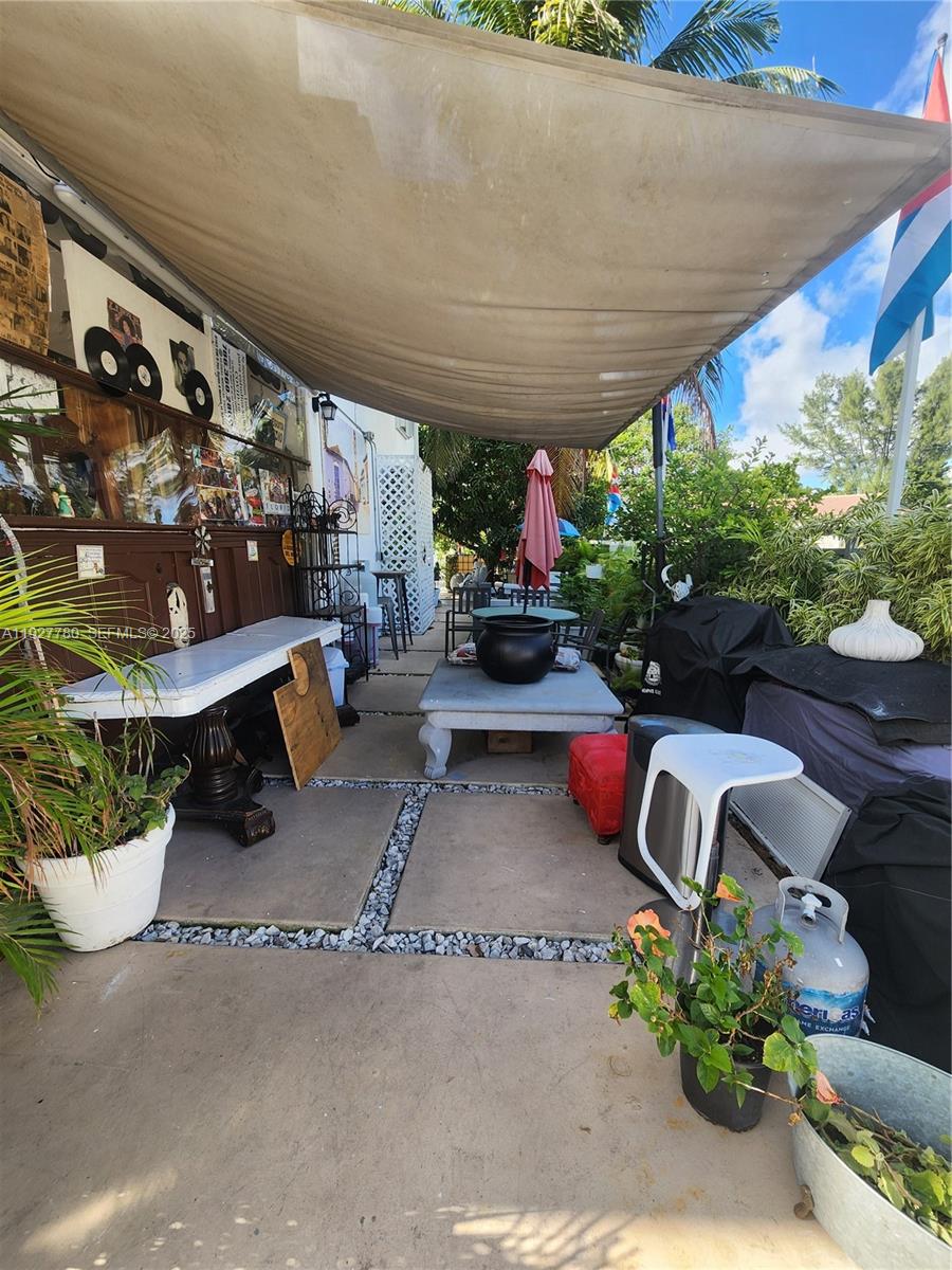 1645 Southwest 83rd Ct. Miami, FL 33155 - Photo 38 of 45 a view of a chairs and table in backyard