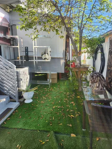 a view of a backyard with sitting area