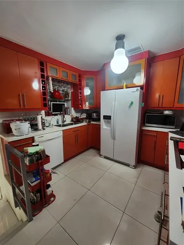a kitchen with stainless steel appliances granite countertop a stove and a refrigerator