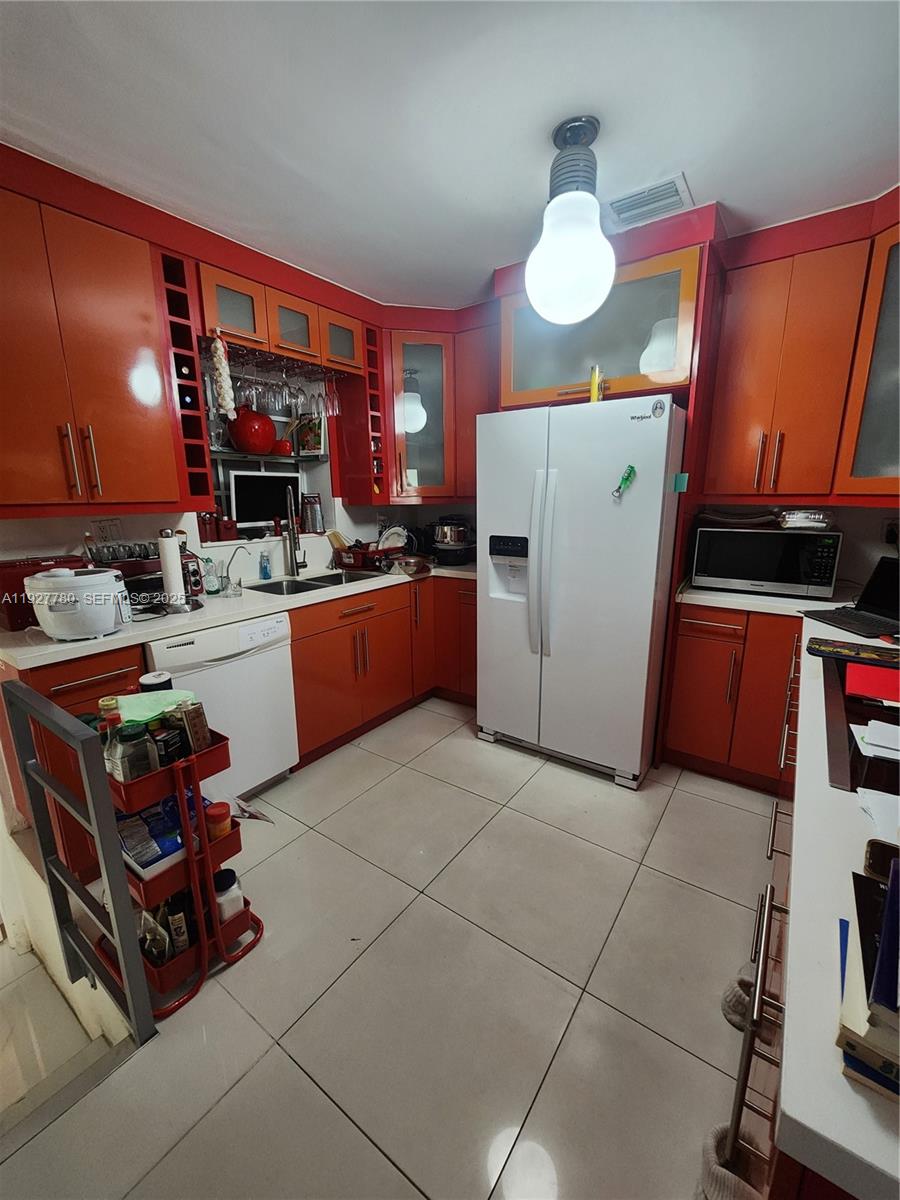 1645 Southwest 83rd Ct. Miami, FL 33155 - Photo 7 of 45 a kitchen with stainless steel appliances granite countertop a stove and a refrigerator