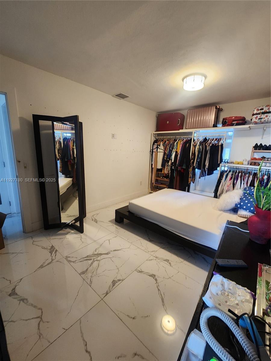 1645 Southwest 83rd Ct. Miami, FL 33155 - Photo 10 of 45 a bedroom with a bed and window