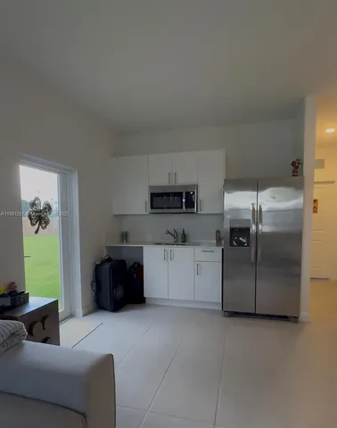 a kitchen with stainless steel appliances granite countertop a refrigerator and a stove
