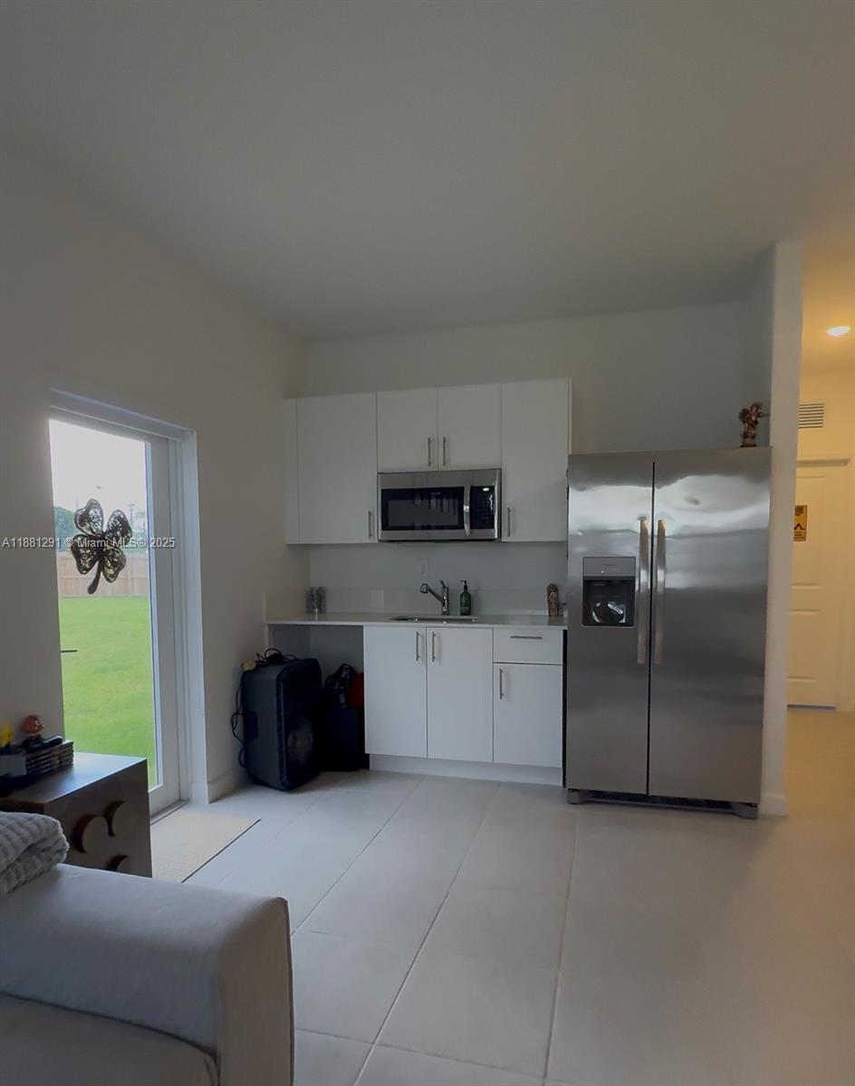 a kitchen with stainless steel appliances granite countertop a refrigerator and a stove