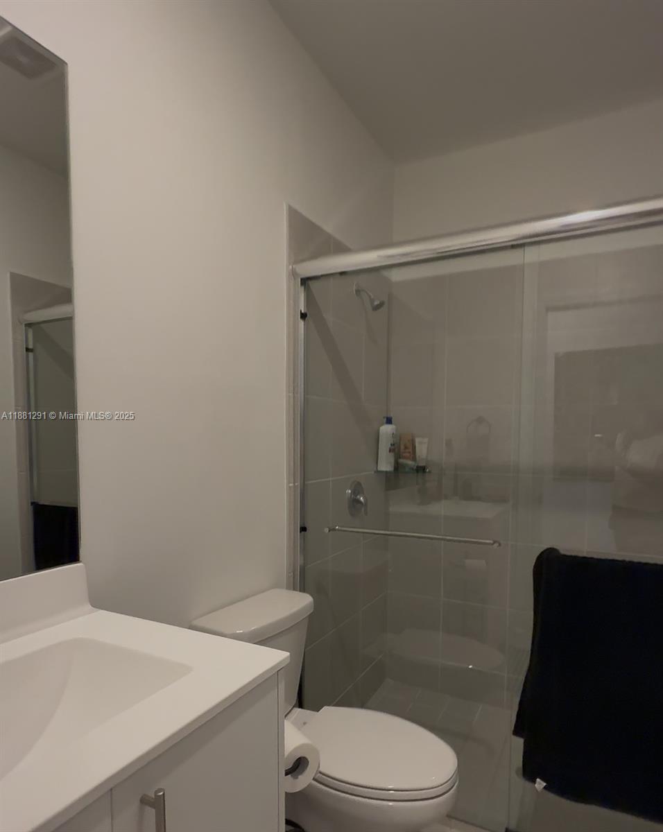 2415 Southeast 23rd Road Homestead, FL 33035 - Photo 3 of 6 a bathroom with a sink a toilet and shower