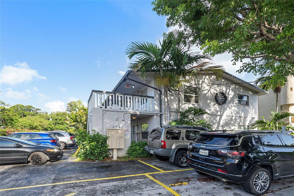 2741 Northeast 8th Avenue, Unit 20 Wilton Manors, FL 33334 - Photo 16 of 25 a car parked in front of a house