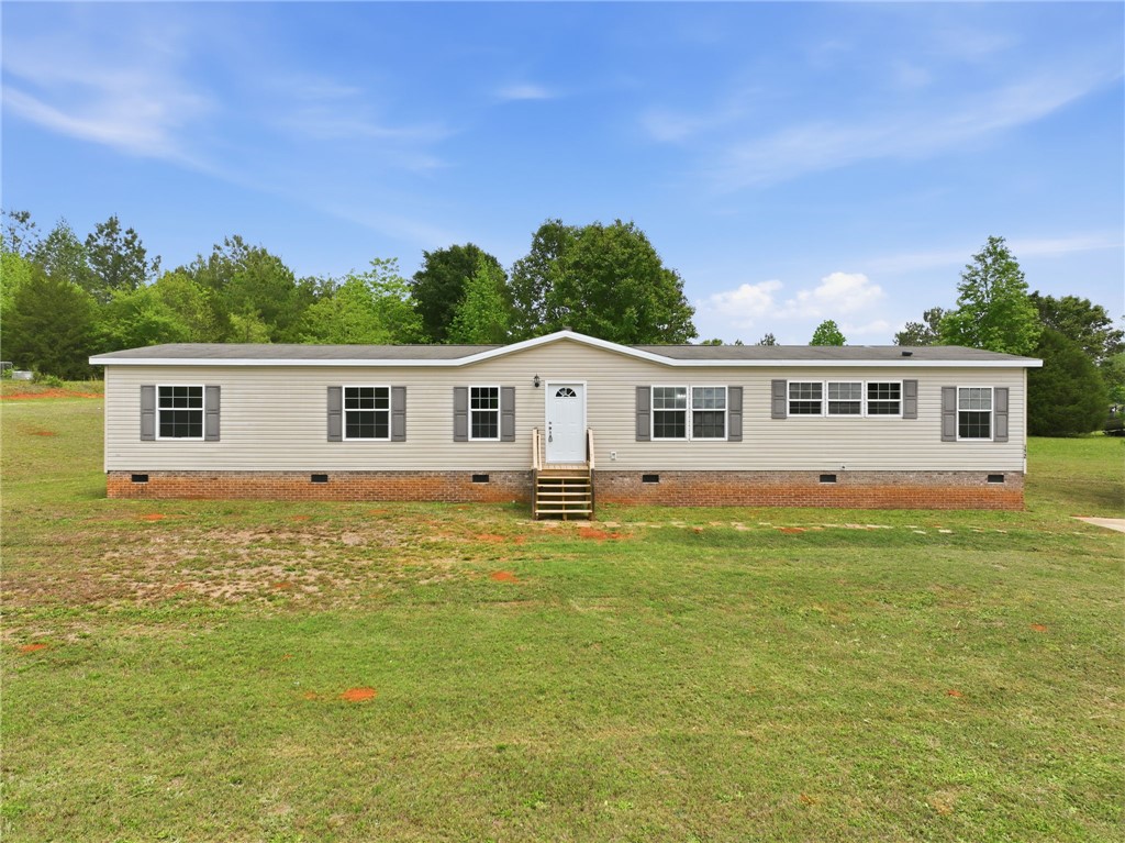 112 Sir Francis Drake Way Liberty, SC 29657 - Photo 2 of 42 This charming home offers a serene escape with its inviting facade and expansive green surroundings.