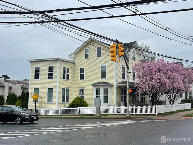 a view of a white house on the street side