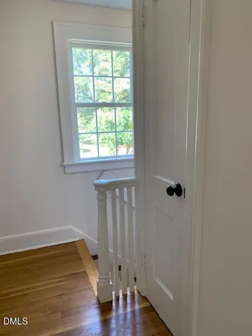 a view of staircase with white walls and a window