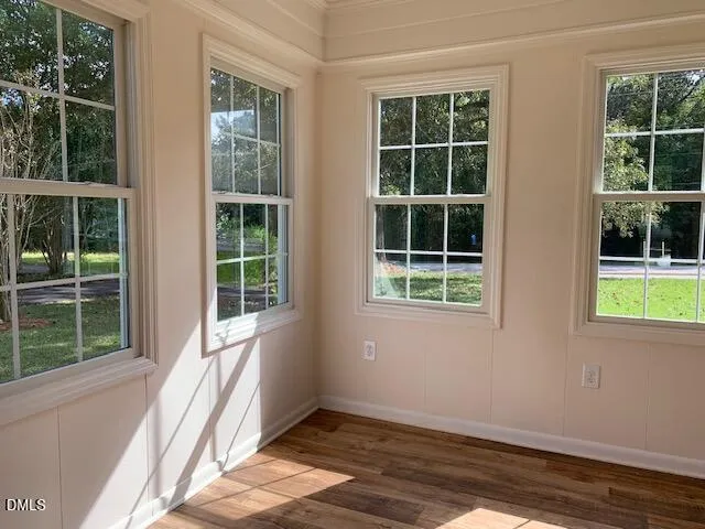 a backyard of a house with potted plants and a bench