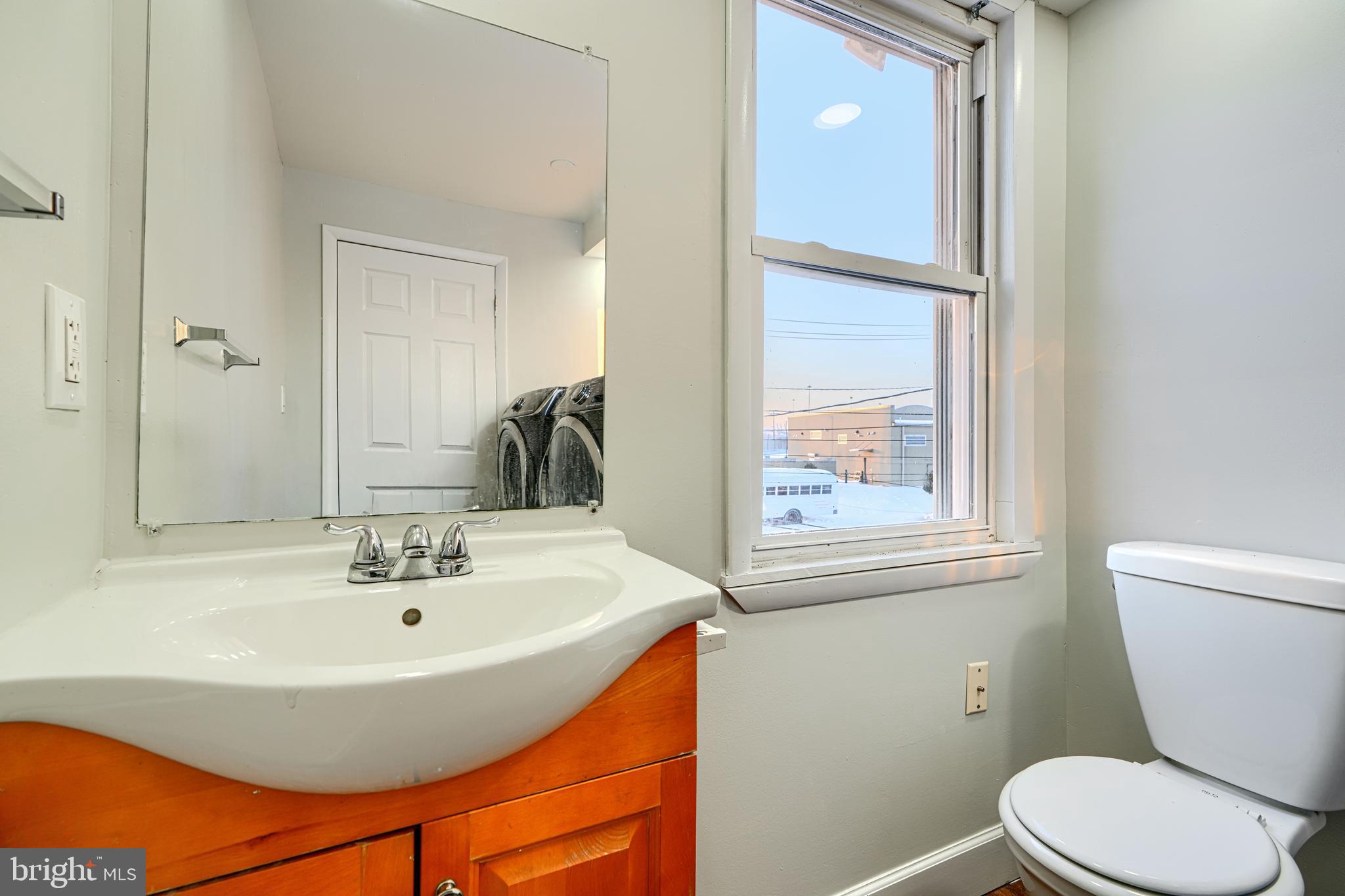 402 Chestnut Court Dundalk, MD 21222 - Photo 11 of 36 a bathroom with a sink a toilet and mirror