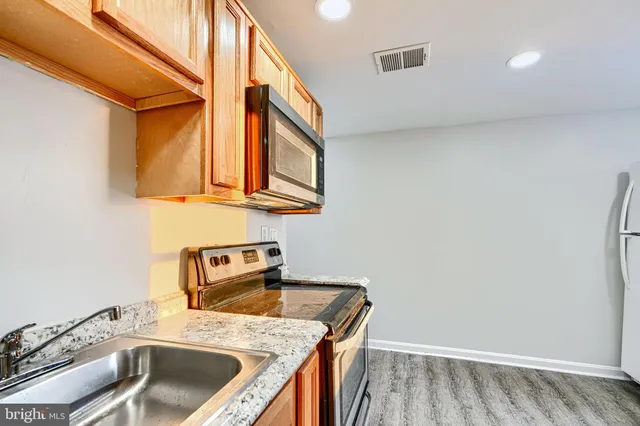 a utility room with a sink a stove and washer