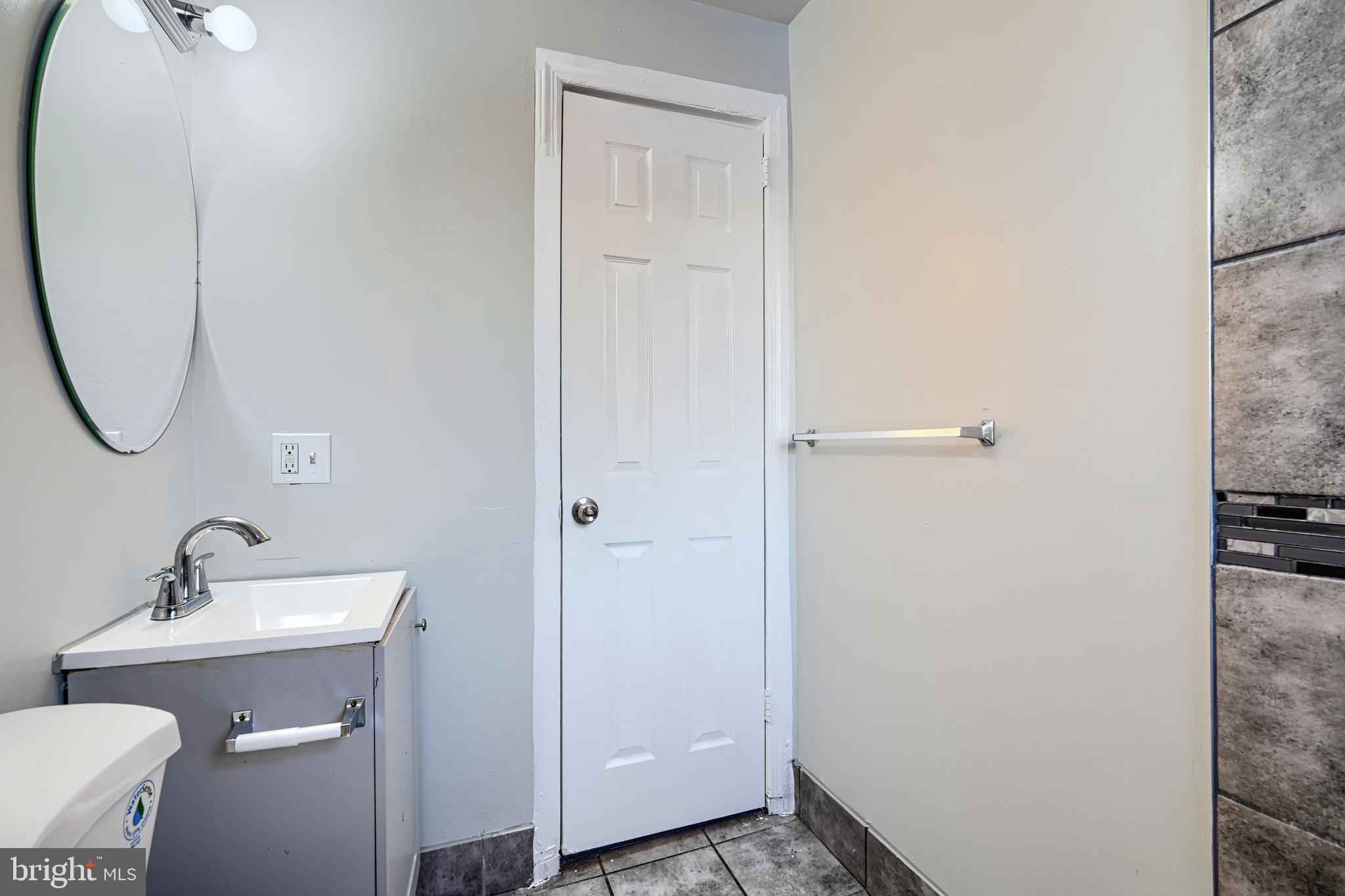402 Chestnut Court Dundalk, MD 21222 - Photo 29 of 36 a bathroom with a sink and mirror