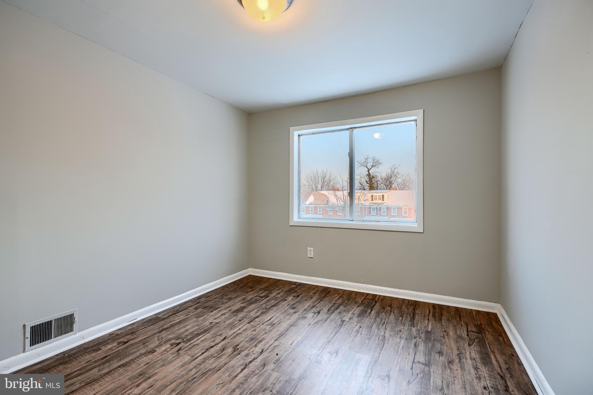 402 Chestnut Court Dundalk, MD 21222 - Photo 31 of 36 wooden floor in an empty room with a window