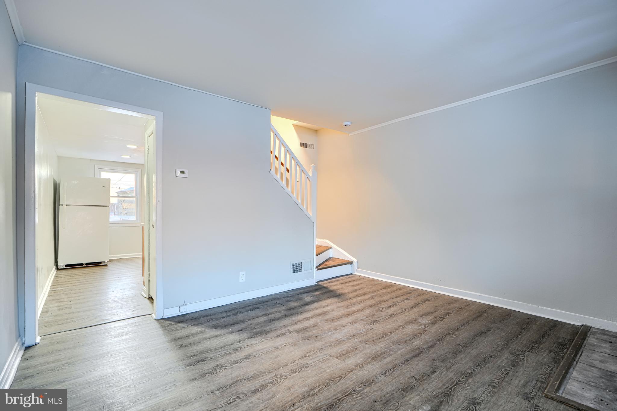 402 Chestnut Court Dundalk, MD 21222 - Photo 34 of 36 an empty room with wooden floor and windows