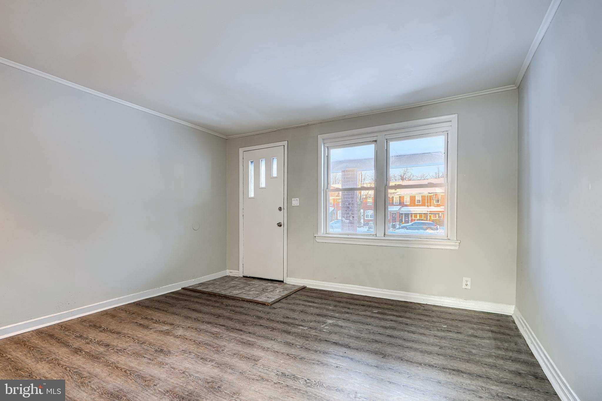 402 Chestnut Court Dundalk, MD 21222 - Photo 35 of 36 an empty room with wooden floor and windows