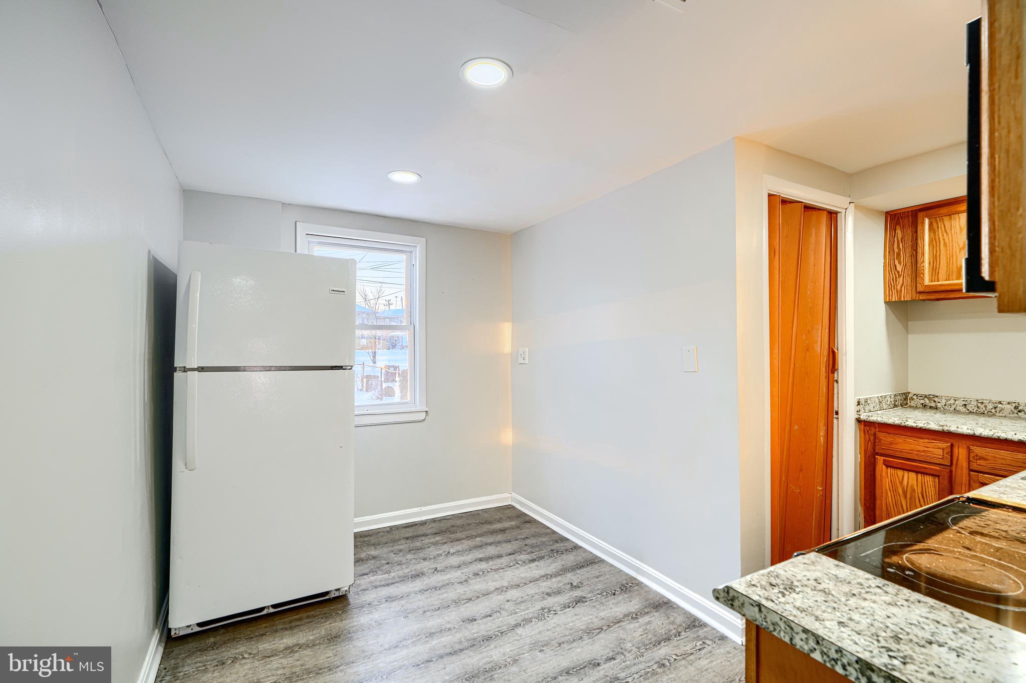 402 Chestnut Court Dundalk, MD 21222 - Photo 36 of 36 a view of kitchen with a refrigerator wooden floor and cabinets