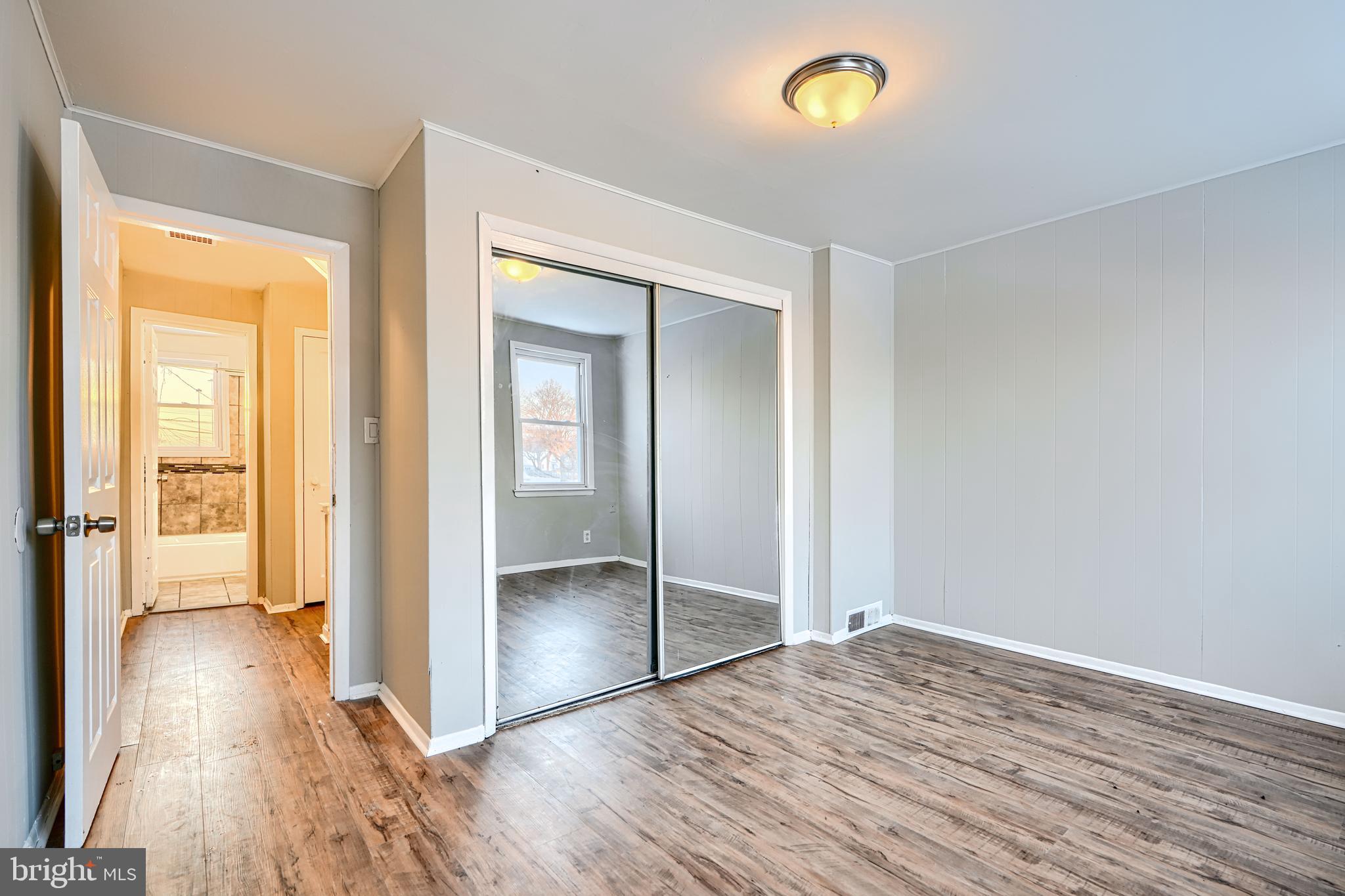 402 Chestnut Court Dundalk, MD 21222 - Photo 6 of 36 wooden floor in an empty room with a window