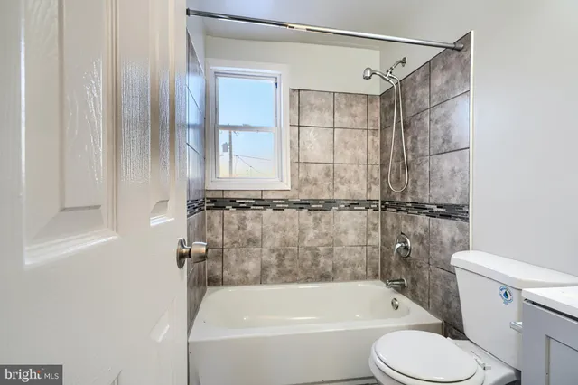 a bathroom with a toilet and a bathtub