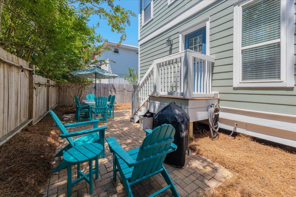 67 Snapper Street Santa Rosa Beach, FL 32459 - Photo 42 of 48 a view of a patio with table and chairs and wooden fence