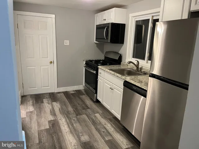 a kitchen with stainless steel appliances a refrigerator sink and stove