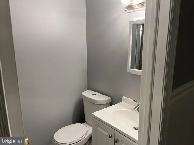 a white toilet sitting next to a bathroom sink