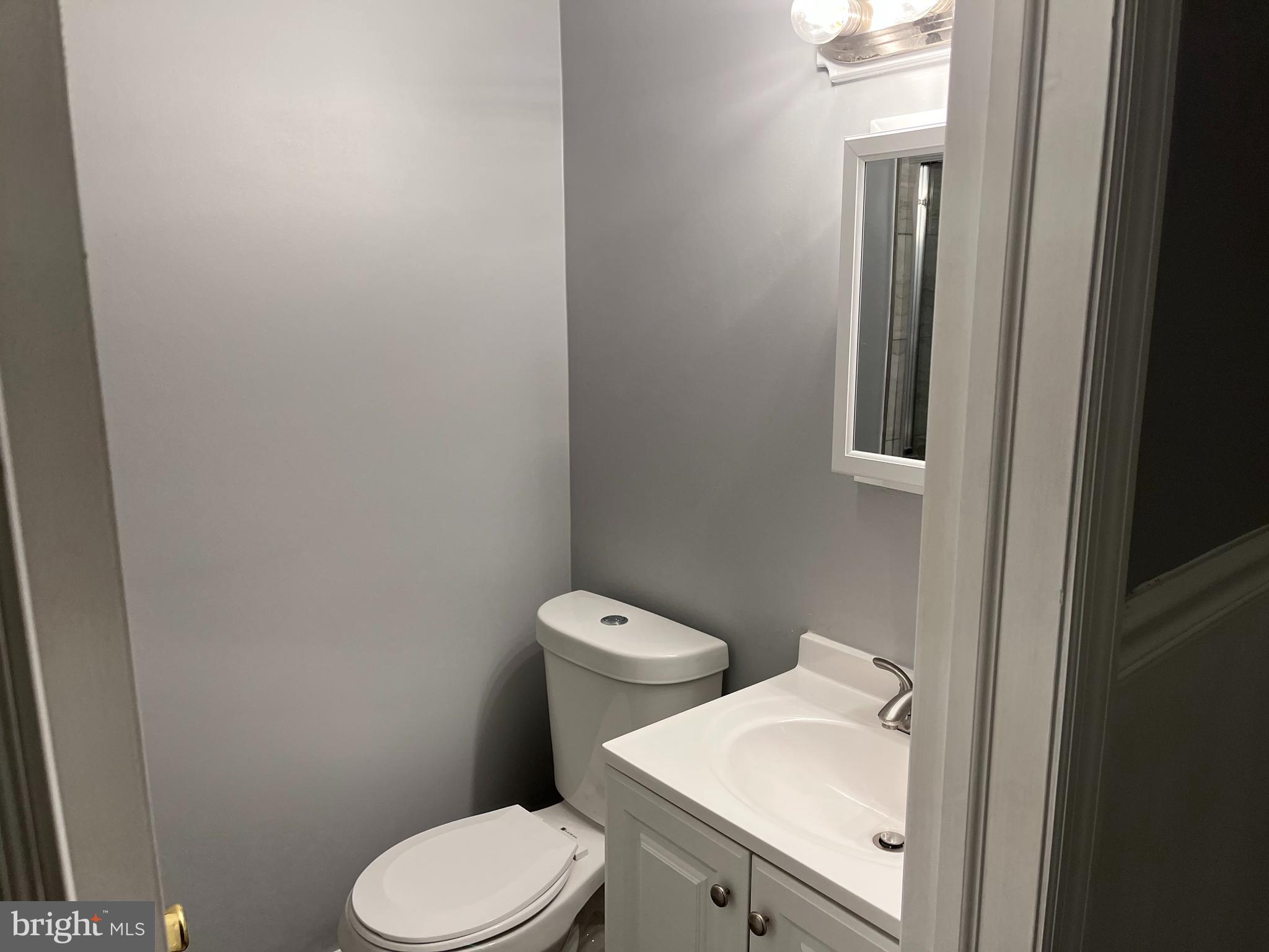 262 Crown Point Road, Unit A Thorofare, NJ 08086 - Photo 4 of 7 a white toilet sitting next to a bathroom sink