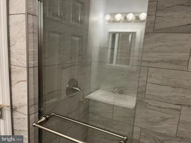 a bathroom with a sink a mirror and shower