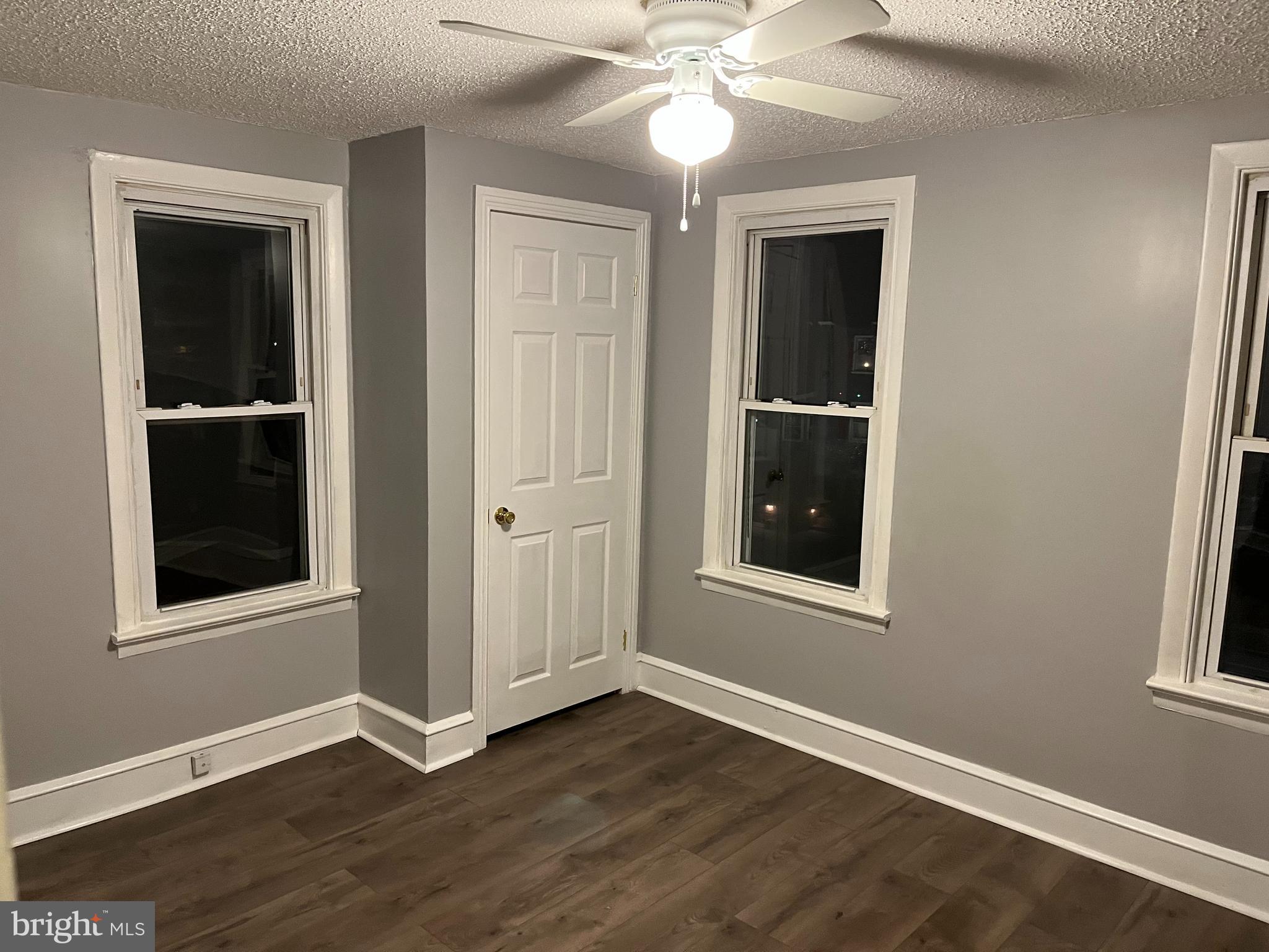 262 Crown Point Road, Unit A Thorofare, NJ 08086 - Photo 6 of 7 an empty room with wooden floor and windows