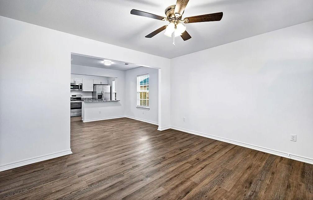 404 East Elm Street Denison, TX 75021 - Photo 7 of 21 wooden floor in an empty room with a window