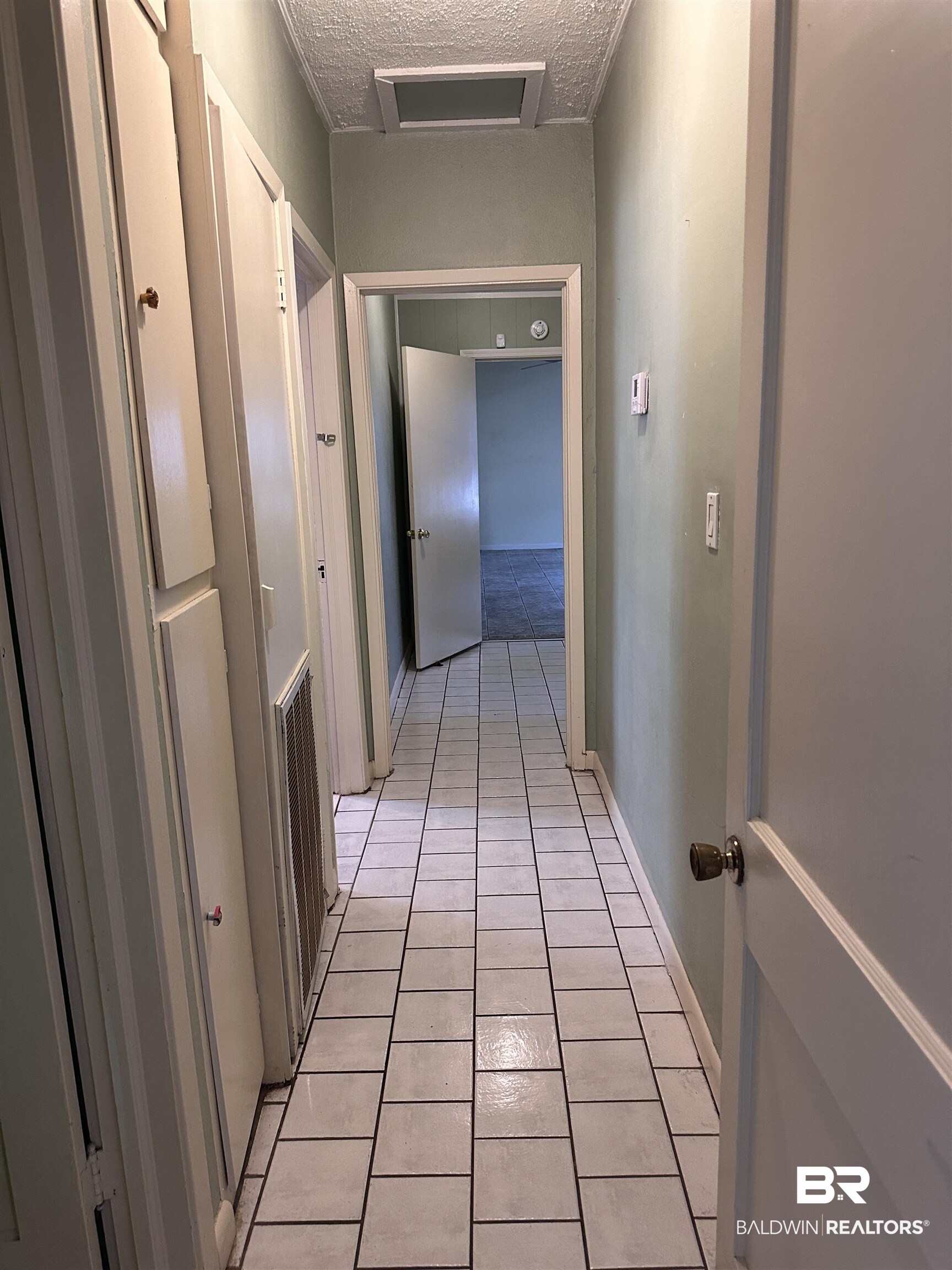16646 County Road 26 Foley, AL 36535 - Photo 11 of 21 Hallway with a textured ceiling and light tile patterned floors