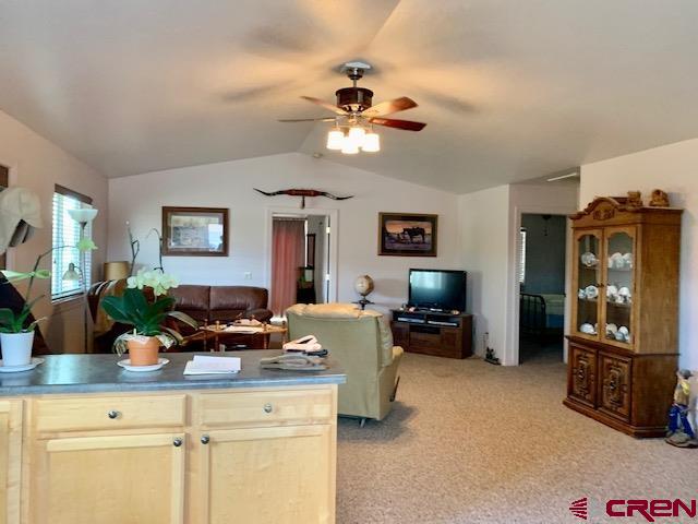 22989 Rd G.5 Cortez, CO 81321 - Photo 14 of 27 a living room with furniture a chandelier and a flat screen tv