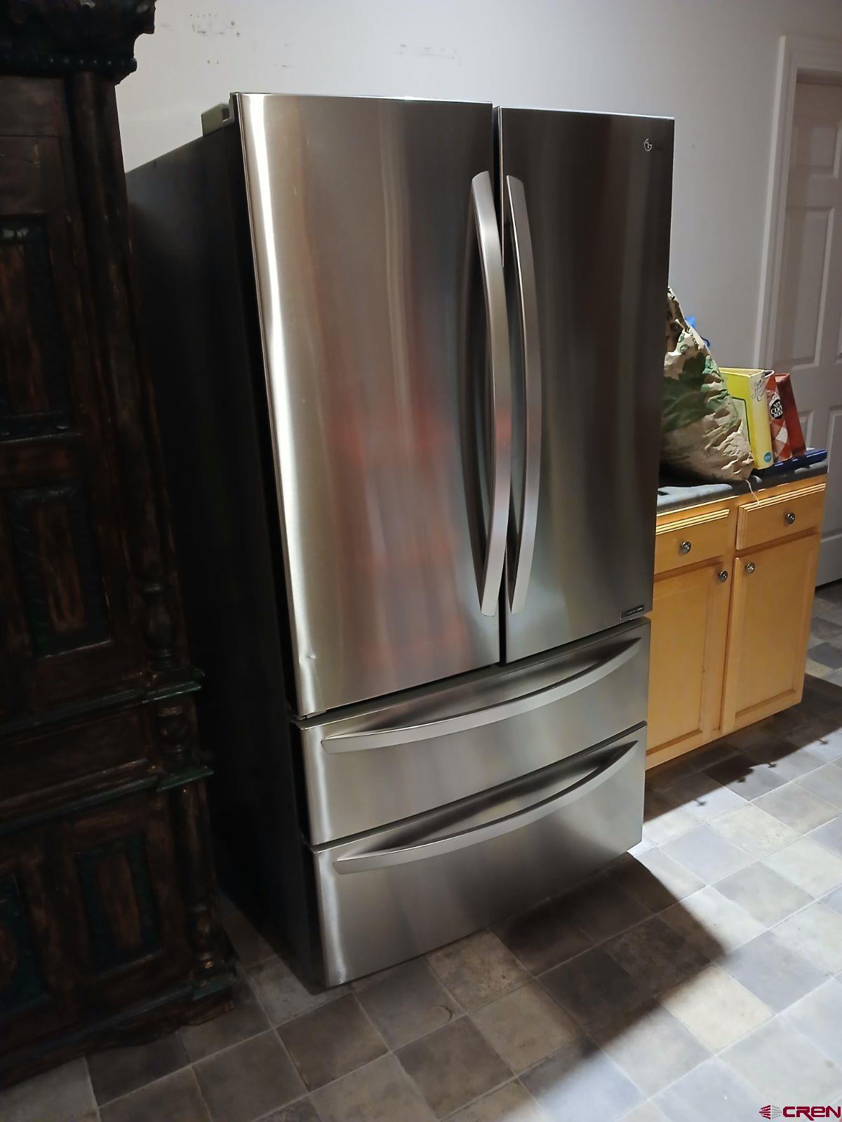 22989 Rd G.5 Cortez, CO 81321 - Photo 17 of 27 a metallic refrigerator freezer sitting in a kitchen