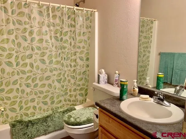 a bathroom with a sink toilet and a mirror