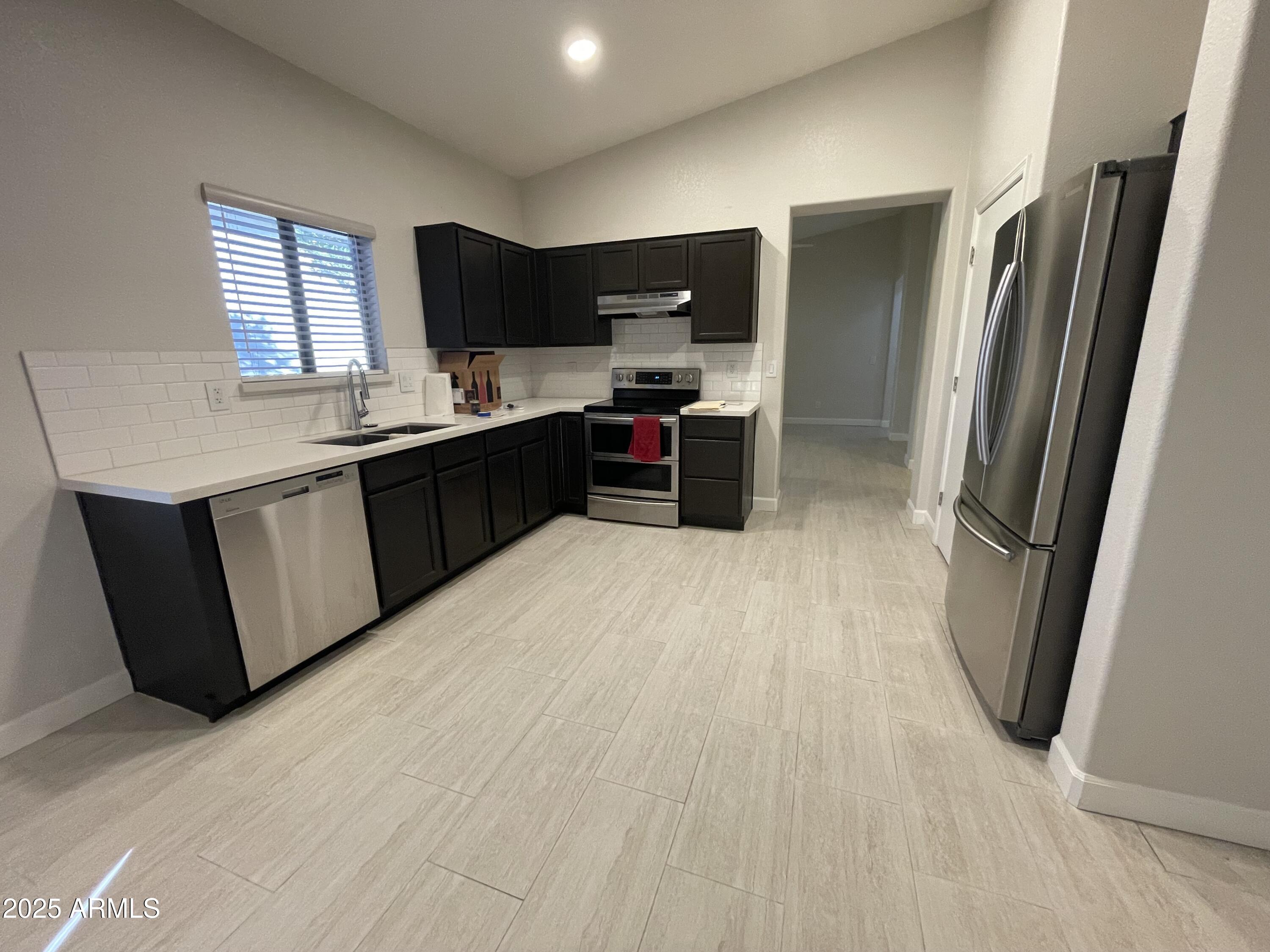 3803 West Commonwealth Avenue Chandler, AZ 85226 - Photo 2 of 15 a kitchen with stainless steel appliances a refrigerator and a sink