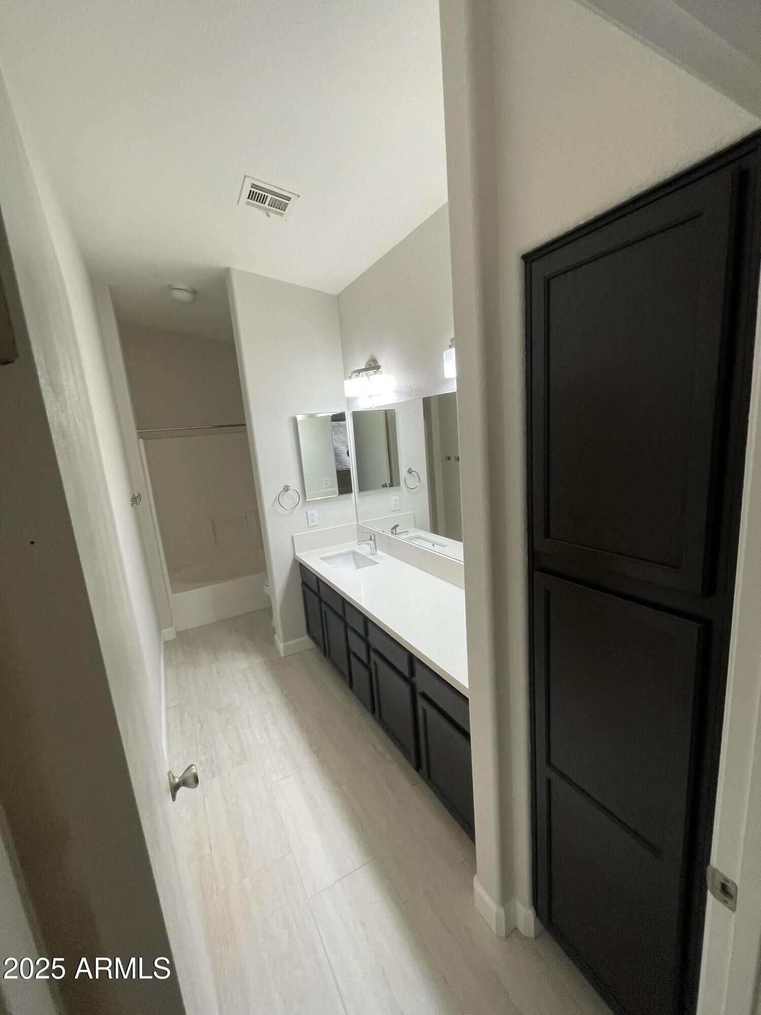3803 West Commonwealth Avenue Chandler, AZ 85226 - Photo 9 of 15 a bathroom with a double vanity sink and mirror