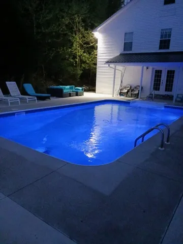 a view of a pool with a yard