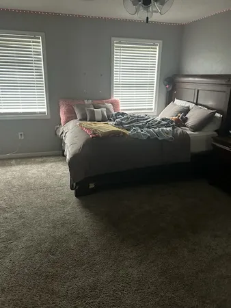 a bedroom with a bed and window