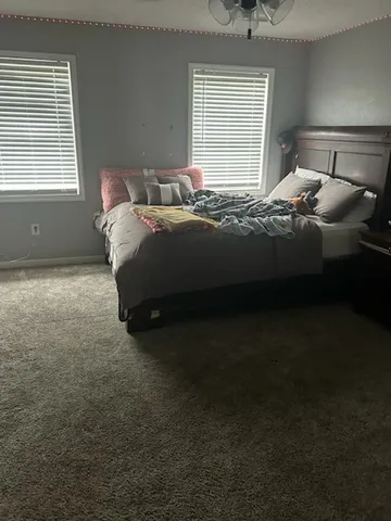 a bedroom with a bed and window