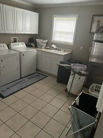 a room with a sink cabinets and wooden floor
