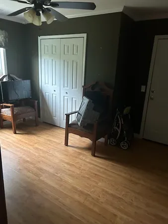 a view of a livingroom with furniture and staircase