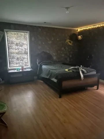 a bedroom with a bed and a window