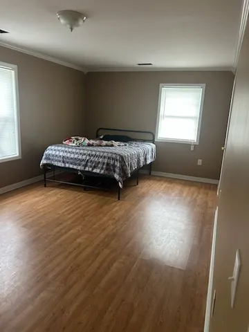 a bedroom with a bed and window