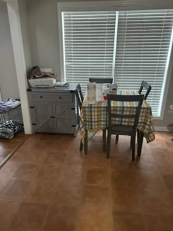 a view of a room that has a window and a chair